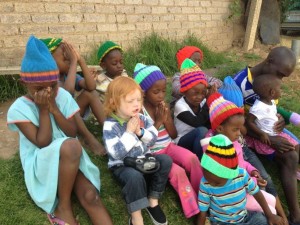 Cael praying with a group of children in the township where our gardener and friend Michael lives, November 2013